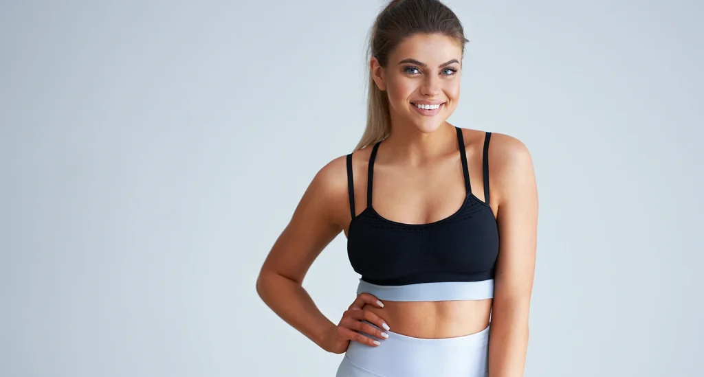 happy athletic woman posing sports bra