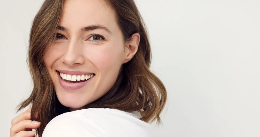 closeup portrait of young happy woman looking in camera