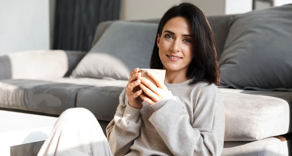 Beautiful woman relaxing at a couch at home